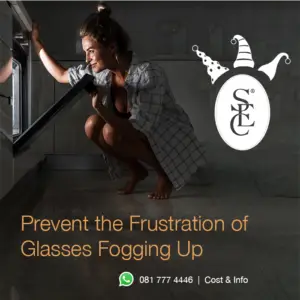 An image of a woman crouching and smiling as she looks into an oven, with the text 'Prevent the Frustration of Glasses Fogging Up.' The Sandton Eye Clinic logo is visible in the top left corner, with festive party hats added for a holiday touch.